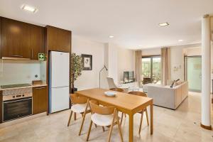 a kitchen and dining room with a table and chairs at Stylish Townhouse In Tavira Centre, Shared Pool in Tavira