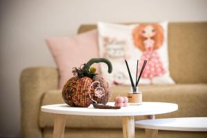 a pumpkin sitting on a table in front of a couch at Sea & Mountain Horizon by Myrto in Diakopto