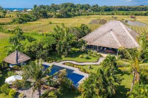 an aerial view of a resort with a swimming pool at North Bali Beachhouse Ayu in Umeanyar