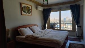 A bed or beds in a room at Nile House
