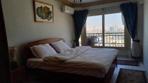 A bed or beds in a room at Nile House