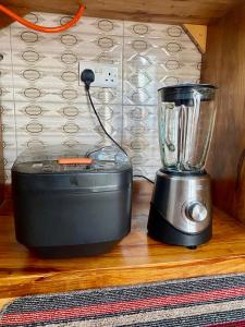 a blender sitting on a wooden counter next to a blender at Sweet Family & Friendly home in Kunduchi in Dar es Salaam