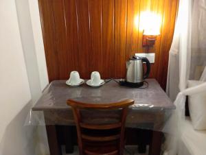a table with a tea kettle on top of it at Happy Stay Mirissa in Mirissa +28 photos
