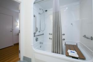 a bathroom with a bath tub with a shower at Motel 6-Brooklyn Center, MN - Minneapolis in Brooklyn Center +60 photos