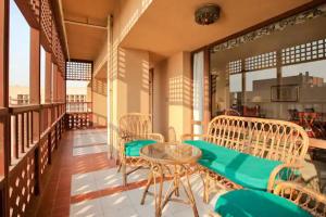 a balcony with a table and chairs on a building at Cairo house in Cairo +4 photos