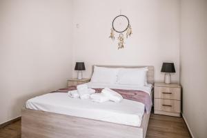 a bedroom with a bed with two towels on it at CityView 2 fully equipped apt by Hospi in Heraklio Town