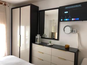 a bedroom with a dresser and a mirror at Quatrecantons Camprodon in Camprodon
