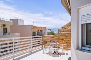 a balcony with two chairs and a fence at CityView 2 fully equipped apt by Hospi in Heraklio Town