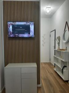 a room with a television on a wall with a counter at Arona Lovely House in Arona