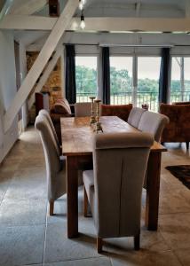 a dining room with a wooden table and chairs at Les Constancies luxury Villa 24-34 pers in Valades