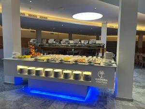 a buffet line with food on display in a building at Hotel Madeira Centro in Benidorm
