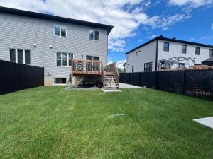 a backyard with a deck and a house at Luxurya in Drummondville
