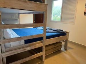 two bunk beds in a room with a window at Casa na Praia de Santiago, próxima a Maresias! in São Sebastião +48 photos