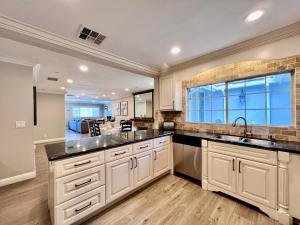 a kitchen with white cabinets and a large window at Destination #32 in Anaheim
