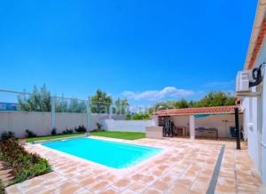 a swimming pool in the backyard of a house at Petit cocon in Fos-sur-Mer