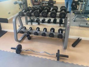 a row of dumbbells on a rack in a gym at Hotel Madeira Centro in Benidorm