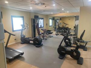 a gym with several tread machines in a room at Hotel Madeira Centro in Benidorm