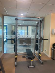 a room with a gym with a chair and a mirror at Hotel Madeira Centro in Benidorm