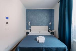 Postel nebo postele na pokoji v ubytování Franciacorta Rooms