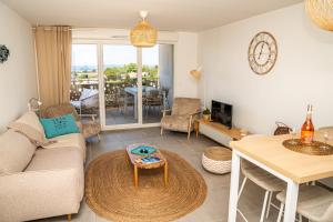 a living room with a couch and a table at Sete, Thau Indigo B402 in Sète