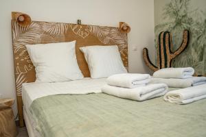 a bedroom with a bed with towels on it at Sete, Thau Indigo B402 in Sète