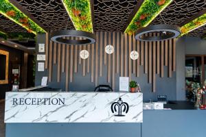 a reception area with clocks on the wall at Hotel Royal Bath in Banya