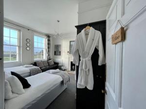 a bedroom with a robe hanging on a door at Uplands House Tewkesbury in Tewkesbury