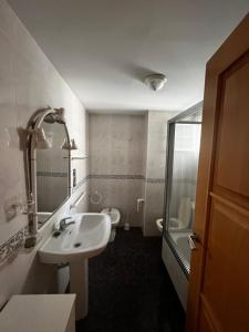 a bathroom with a sink and a toilet at Bacarola in Los Mártires +6 photos