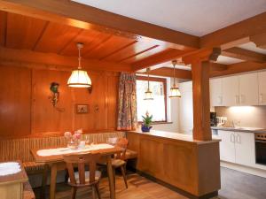 a kitchen with a table and a dining room at Ferienchalet HOLDERNACH in Kappl