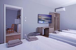 Posteľ alebo postele v izbe v ubytovaní Aviator Garni Hotel Bratislava