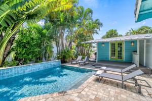 a villa with a swimming pool and a house at Toes in the Sand - 113 in Sarasota