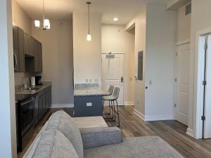 a living room with a kitchen with a counter top at Strongback Suite 205 in Adrian +15 photos