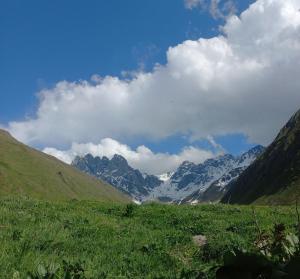 a view of a mountain range with snow covered mountains at Cottage Hillside in Juta in Jut'a