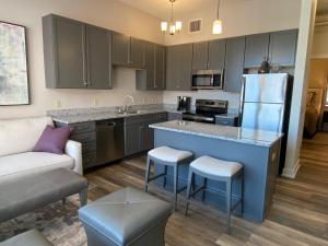 a kitchen with a blue island in a living room at Strongback Suite 207 in Adrian