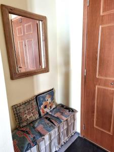 a couch with a teddy bear sitting on it next to a door at Syros 41 in Ermoupoli