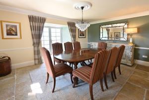 a dining room with a wooden table and chairs at Milton House in Buchanty +18 photos