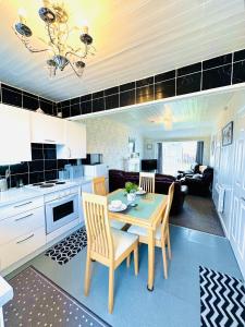 a kitchen and living room with a table and chairs at Warren Cottage in Bridlington +36 photos
