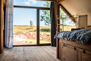 a bedroom with a bed and a large sliding glass door at Řasnická stodola in Horní Řasnice