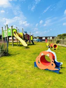 a playground with a bunch of different types of slides at Warren Cottage in Bridlington