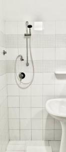 a white bathroom with a shower and a sink at La casa di mammona in Semivicoli