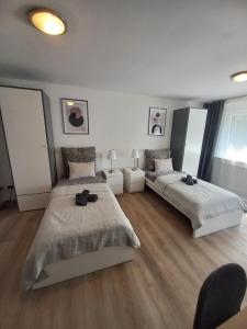 a white room with two beds and a couch at Paula - Bergheim-Köln Wohlfühlapartment in Bergheim