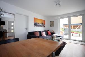a living room with a couch and a table at Ferienwohnung Will in Bodman-Ludwigshafen +2 photos