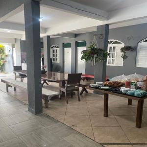 a living room with a table with food on it at Hope Hostel Praia do Morro in Guarapari