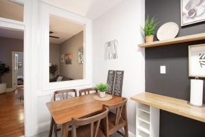 a dining room with a table and chairs and a mirror at Hoboken 15 Min Train to Manhattan Full Kitchen in Hoboken +15 photos