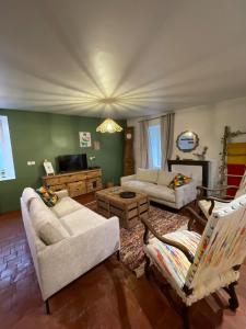 a living room with two couches and a tv at "L'escargot" Maison familiale - Les Terres du Roy in Avallon