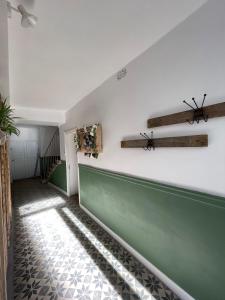 a hallway with a green and white wall at "L'escargot" Maison familiale - Les Terres du Roy in Avallon +53 photos