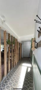 a hallway of a house with a wall of logs at "L'escargot" Maison familiale - Les Terres du Roy in Avallon