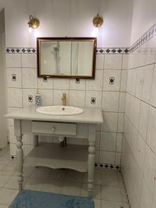 a bathroom with a sink and a mirror at "L'escargot" Maison familiale - Les Terres du Roy in Avallon