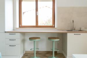 una cocina con dos taburetes bajo una ventana en Relais del Parco Verde e Relais del Parco Rosso, en LʼAquila 34 fotos más