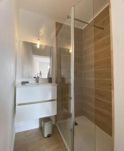 a bathroom with a glass shower and a sink at Parking, spacieux, calme, central - Coconhome in Talence